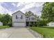 Traditional two-story home boasts a well-manicured lawn and an attached two-car garage at 1119 Albemarle Cir, Noblesville, IN 46062