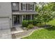 Charming front entrance with manicured landscaping, including lush bushes and a blooming tree at 1119 Albemarle Cir, Noblesville, IN 46062