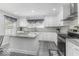 A bright kitchen features white cabinets, stainless appliances, and a gray countertop island at 1119 Albemarle Cir, Noblesville, IN 46062