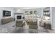 Cozy living room featuring a fireplace and large windows with views of the outdoors at 1119 Albemarle Cir, Noblesville, IN 46062