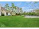Green backyard with mature trees and view of the water, creating a private and peaceful setting at 11199 Boston Way, Fishers, IN 46038