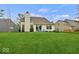 Well-maintained backyard, including two outdoor chairs and a private setting with mature trees at 11199 Boston Way, Fishers, IN 46038