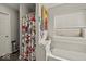 Clean bathroom with a combination bathtub and shower, featuring colorful floral shower curtain at 11199 Boston Way, Fishers, IN 46038