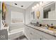 Bathroom with double sink vanity, modern fixtures, large mirrors and bath tub at 11199 Boston Way, Fishers, IN 46038