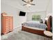 Comfortable carpeted bedroom with ceiling fan, closet and natural light from the window at 11199 Boston Way, Fishers, IN 46038
