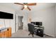 Spacious bedroom with a ceiling fan, neutral walls and versatile as an office space at 11199 Boston Way, Fishers, IN 46038