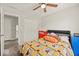 Cozy bedroom with a ceiling fan, colorful bedding and easy access to the home's upper level at 11199 Boston Way, Fishers, IN 46038