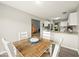 Cozy dining area with view to kitchen and living area features wood table and seating for four at 11199 Boston Way, Fishers, IN 46038