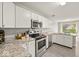 Modern kitchen featuring stainless steel appliances, granite countertops, and ample cabinet space at 11199 Boston Way, Fishers, IN 46038