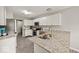Modern kitchen featuring stainless steel appliances, granite countertops, and ample cabinet space at 11199 Boston Way, Fishers, IN 46038