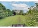 Picturesque backyard view showcasing a large, well-maintained lawn and beautiful, mature trees at 11508 Willow Ridge Dr, Zionsville, IN 46077