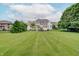 Expansive backyard featuring a lush lawn and mature trees, creating a serene outdoor space at 11508 Willow Ridge Dr, Zionsville, IN 46077