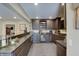 An elegant basement bar with custom cabinets, stone countertops, and ample seating with a casual aesthetic at 11508 Willow Ridge Dr, Zionsville, IN 46077