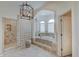 This bathroom features a soaking tub, glass block wall, and a walk-in shower at 11508 Willow Ridge Dr, Zionsville, IN 46077