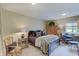 Cozy bedroom featuring a plush bed, neutral color palette, and natural light at 11508 Willow Ridge Dr, Zionsville, IN 46077