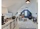 Bright Bedroom featuring a comfortable chair, modern crib, and stylish decor in a cozy attic space at 11508 Willow Ridge Dr, Zionsville, IN 46077