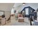 Bright Bedroom featuring a comfortable chair, modern crib, and stylish decor in a cozy attic space at 11508 Willow Ridge Dr, Zionsville, IN 46077