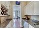 Well-appointed butler pantry featuring granite countertops, custom cabinets, wine storage, and sleek design at 11508 Willow Ridge Dr, Zionsville, IN 46077