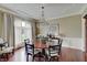 Elegant dining room with hardwood floors, chandelier, and natural light creates a sophisticated dining experience at 11508 Willow Ridge Dr, Zionsville, IN 46077