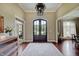 Grand foyer featuring hardwood floors, a decorative chandelier, and an arched doorway, creating a welcoming entrance at 11508 Willow Ridge Dr, Zionsville, IN 46077