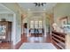 Elegant foyer with hardwood floors, neutral walls, and archway leading to the living room creates a warm, inviting space at 11508 Willow Ridge Dr, Zionsville, IN 46077