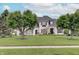 Inviting white home with well-maintained lawn and mature trees showcasing a picturesque and serene setting at 11508 Willow Ridge Dr, Zionsville, IN 46077