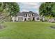 Stunning white home with lush green lawn, mature trees, and manicured landscaping creates idyllic curb appeal at 11508 Willow Ridge Dr, Zionsville, IN 46077