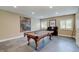 Spacious game room featuring a pool table, piano, and ample space for entertainment at 11508 Willow Ridge Dr, Zionsville, IN 46077