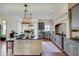 Gourmet kitchen with granite countertops, stainless steel appliances, custom cabinets and designer lighting at 11508 Willow Ridge Dr, Zionsville, IN 46077