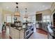 Gourmet kitchen featuring granite countertops, large island with bar seating, and stainless steel appliances at 11508 Willow Ridge Dr, Zionsville, IN 46077