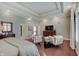 Spacious main bedroom features a tray ceiling, hardwood floors, and seating area at 11508 Willow Ridge Dr, Zionsville, IN 46077