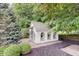 Charming playhouse surrounded by lush greenery, offering a whimsical retreat for children at 11508 Willow Ridge Dr, Zionsville, IN 46077