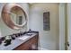 Chic powder room with granite vanity top, decorative mirror, and modern fixtures at 11508 Willow Ridge Dr, Zionsville, IN 46077