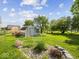 Well-maintained backyard featuring a storage shed and a garden area, perfect for outdoor activities at 116 E Railroad St, Fountaintown, IN 46130