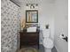 Bathroom featuring patterned shower curtain, mirror, toilet, and sink at 116 E Railroad St, Fountaintown, IN 46130