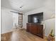 Bedroom featuring large TV, dresser, and a barn door leading to a seating area at 116 E Railroad St, Fountaintown, IN 46130