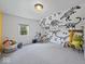 Playful bedroom showcases custom dinosaur wall art at 116 E Railroad St, Fountaintown, IN 46130