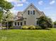 Charming two-story home with manicured lawn and mature trees at 116 E Railroad St, Fountaintown, IN 46130