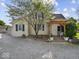 Charming home with a covered porch, mature landscaping, and a gravel front yard at 116 E Railroad St, Fountaintown, IN 46130