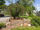Scenic outdoor sitting area featuring decorative ironwork and mature landscaping at 116 E Railroad St, Fountaintown, IN 46130
