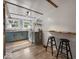 Eat in kitchen boasts rustic wood wall, blue cabinets and natural light at 116 E Railroad St, Fountaintown, IN 46130