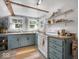Cozy kitchen with blue cabinets, open shelving and rustic wood accents at 116 E Railroad St, Fountaintown, IN 46130