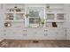 Bright living room with built-in shelving, natural light, and hardwood floors at 116 E Railroad St, Fountaintown, IN 46130
