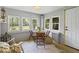 Bright sunroom with multiple windows, a dining table, and a cozy atmosphere at 116 E Railroad St, Fountaintown, IN 46130