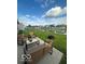 Scenic backyard patio with chairs, bench, a fire pit, and a calming pond view at 1287 Northcraft Ct, Franklin, IN 46131