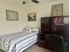 Bright bedroom with a single bed, wood desk, and decorative artwork creates a cozy and functional living space at 1287 Northcraft Ct, Franklin, IN 46131