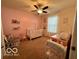 Charming Bedroom with pink accent wall, white crib, rocker and soft carpet at 1287 Northcraft Ct, Franklin, IN 46131