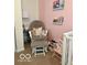Cozy Bedroom featuring a comfortable glider, book shelves and charming decor for a peaceful atmosphere at 1287 Northcraft Ct, Franklin, IN 46131