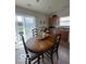 Cozy dining room featuring a wooden table and chairs with view to the exterior patio and yard at 1287 Northcraft Ct, Franklin, IN 46131