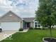 Charming home featuring brick and siding with a well-manicured lawn and attached two car garage at 1287 Northcraft Ct, Franklin, IN 46131
